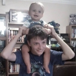 baby brother on big brother's shoulders
