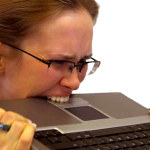 woman biting laptop